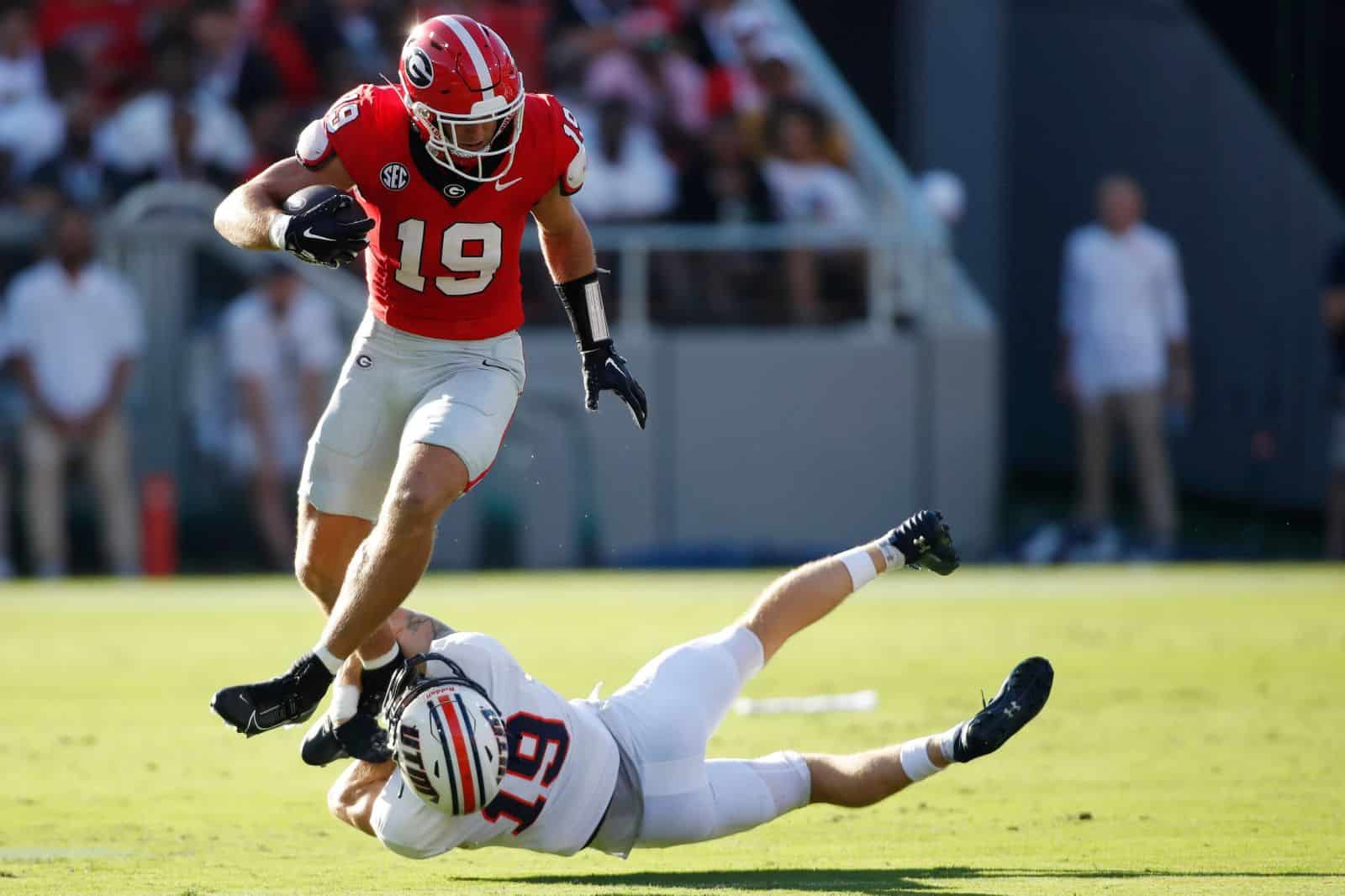 Georgia tight end Brock Bowers (19) avoids a tackle from Tennessee Martin safety Jack Lucas (19) during the first half of a NCAA college football game against Tennessee Martin in Athens, Ga., on Saturday, Sept. 2, 2023.